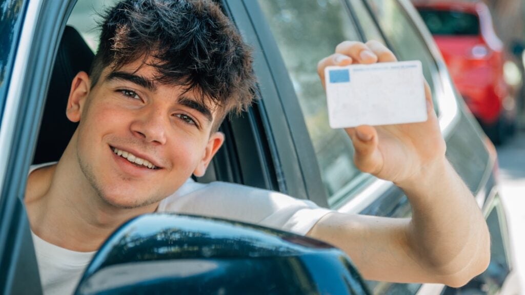 young nobel in the car with driver's license